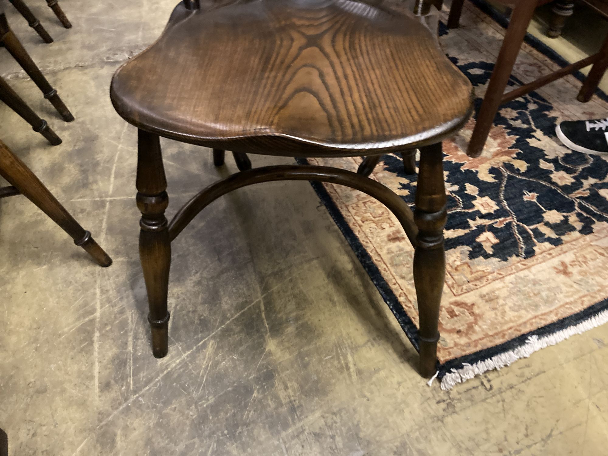 A set of ten stained ash and elm Windsor chairs with crinoline stretchers (two having arms)